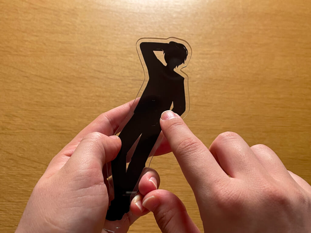 アクスタの表面に爪が当たっている手元